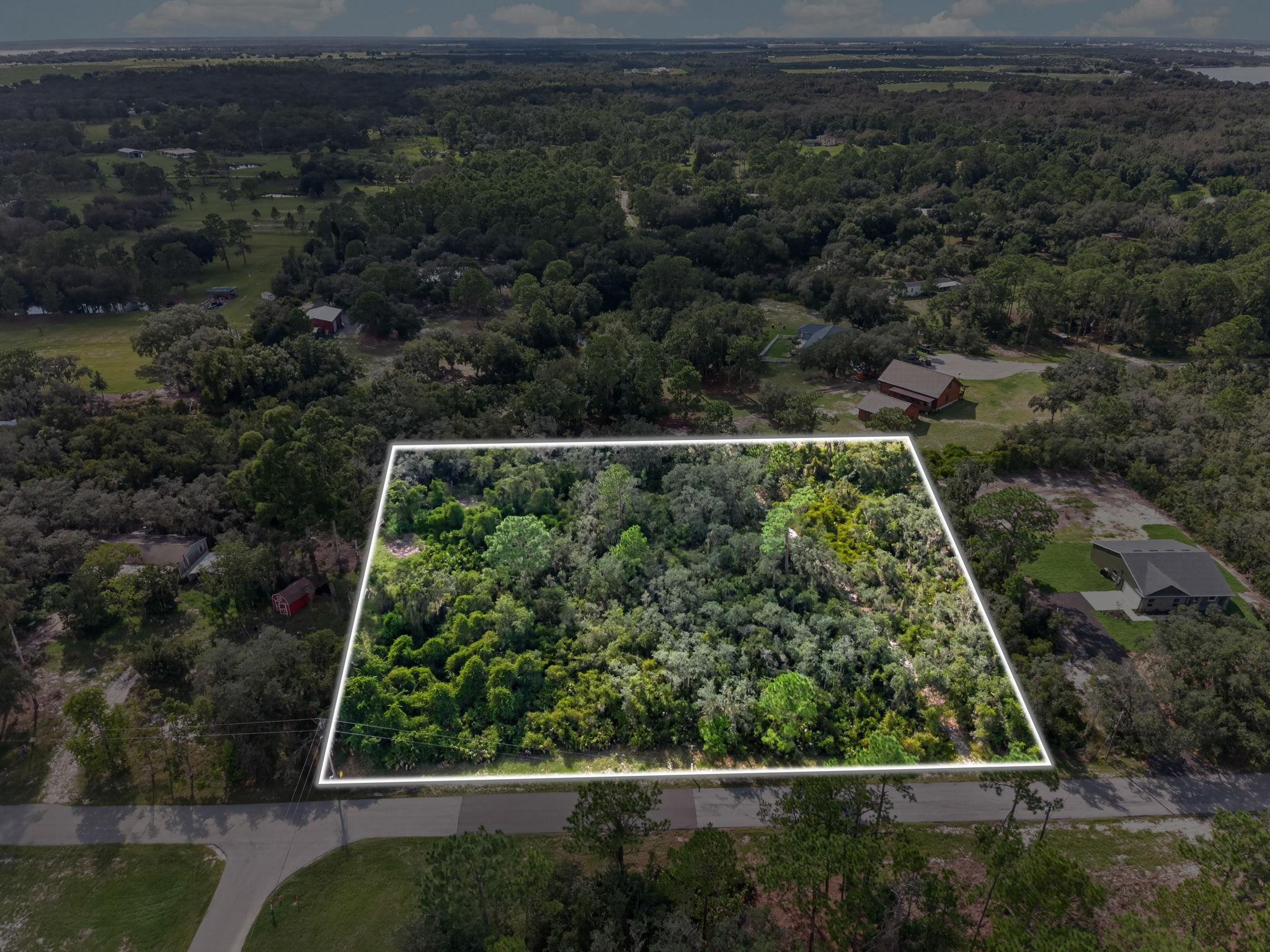 Angled aerial of the lot with lot lines and the road frontage