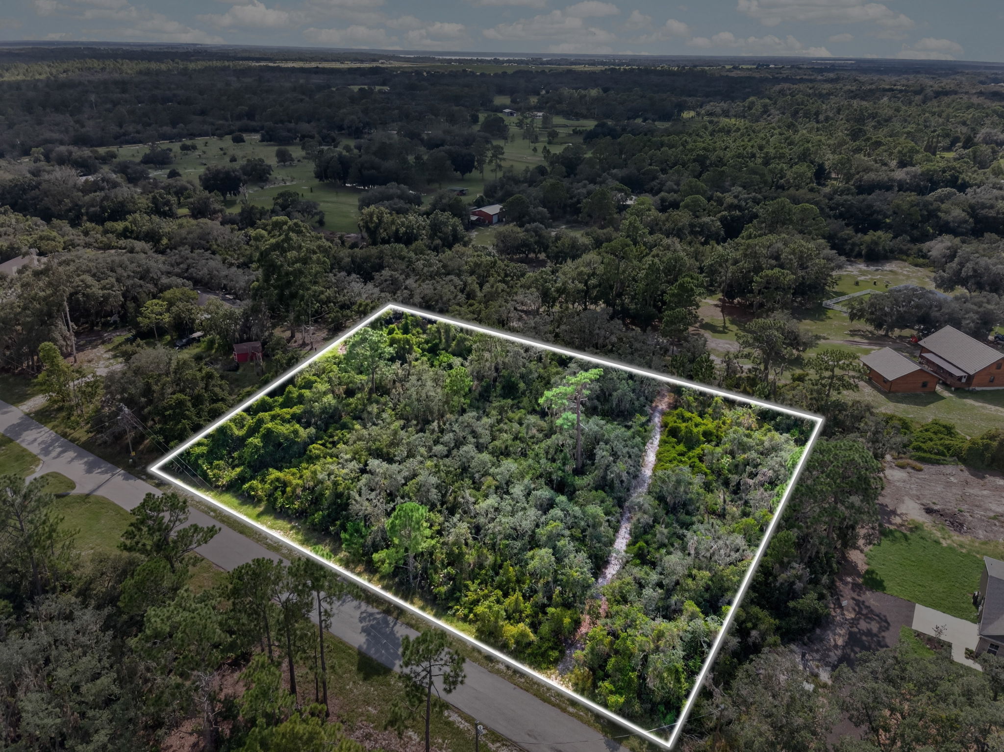 Aerial of the lot with lot lines, neighboring homes in frame