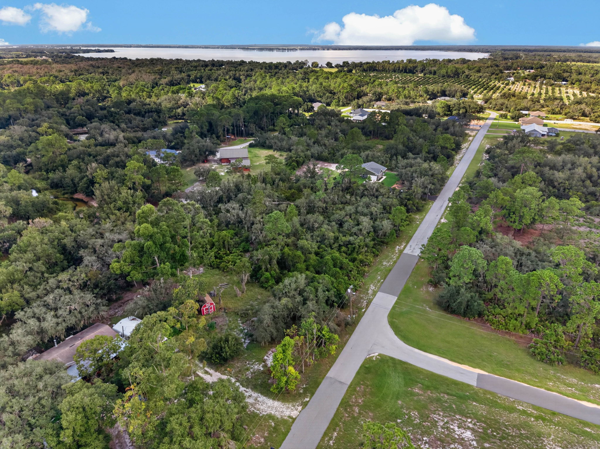 Wide aerial toward the lake with the road through the area